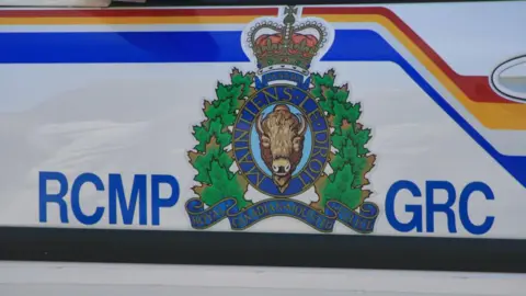 NurPhoto via Getty Images The RCMP logo seen on the side of a police vehicle along with the acronym RCMP/GRC