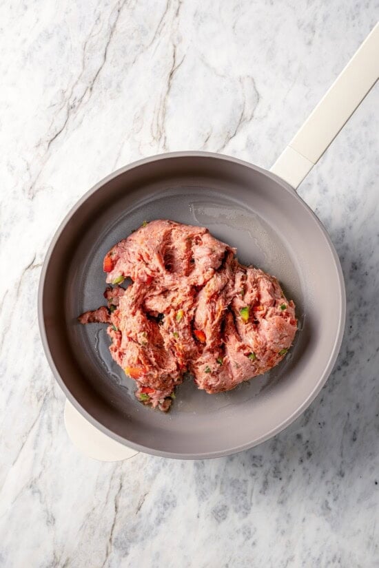 Turkey sausage added to pot with olive oil.